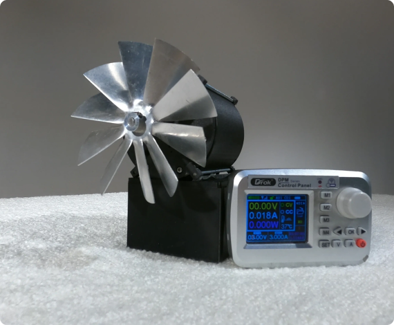 A small metal fan connected to a display panel showing various measurements on a textured surface.